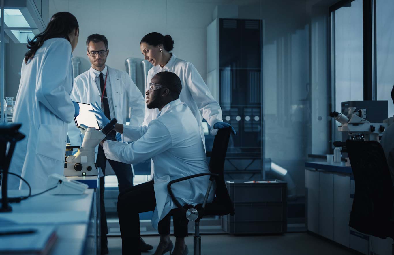 A group of scientists discussing something in a laboratory