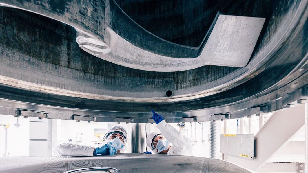 Employees inspecting the inside of the Rosenmund Filter Dryer in the manufacturing area in St. Louis, USA (Cherokee facility).