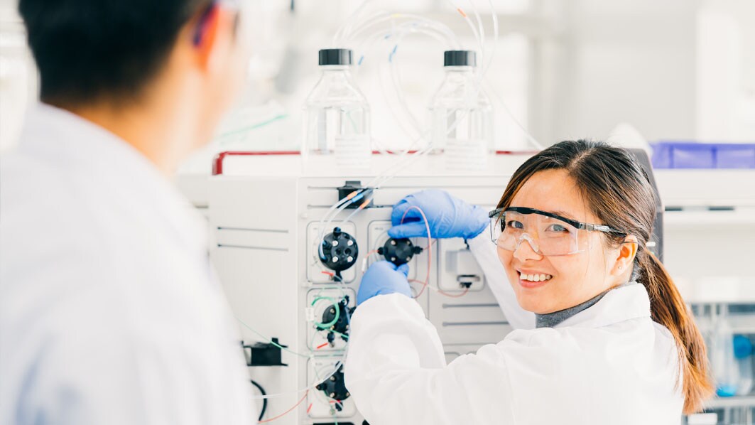 Employees performing test on a small-scale purification system at the End-to-End Biodevelopment Center in Shanghai, China