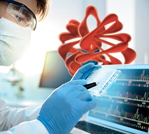 509625117-Scientist examining a microtiter plate