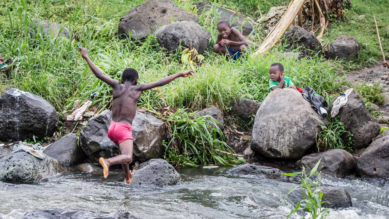 Boys playing at a river