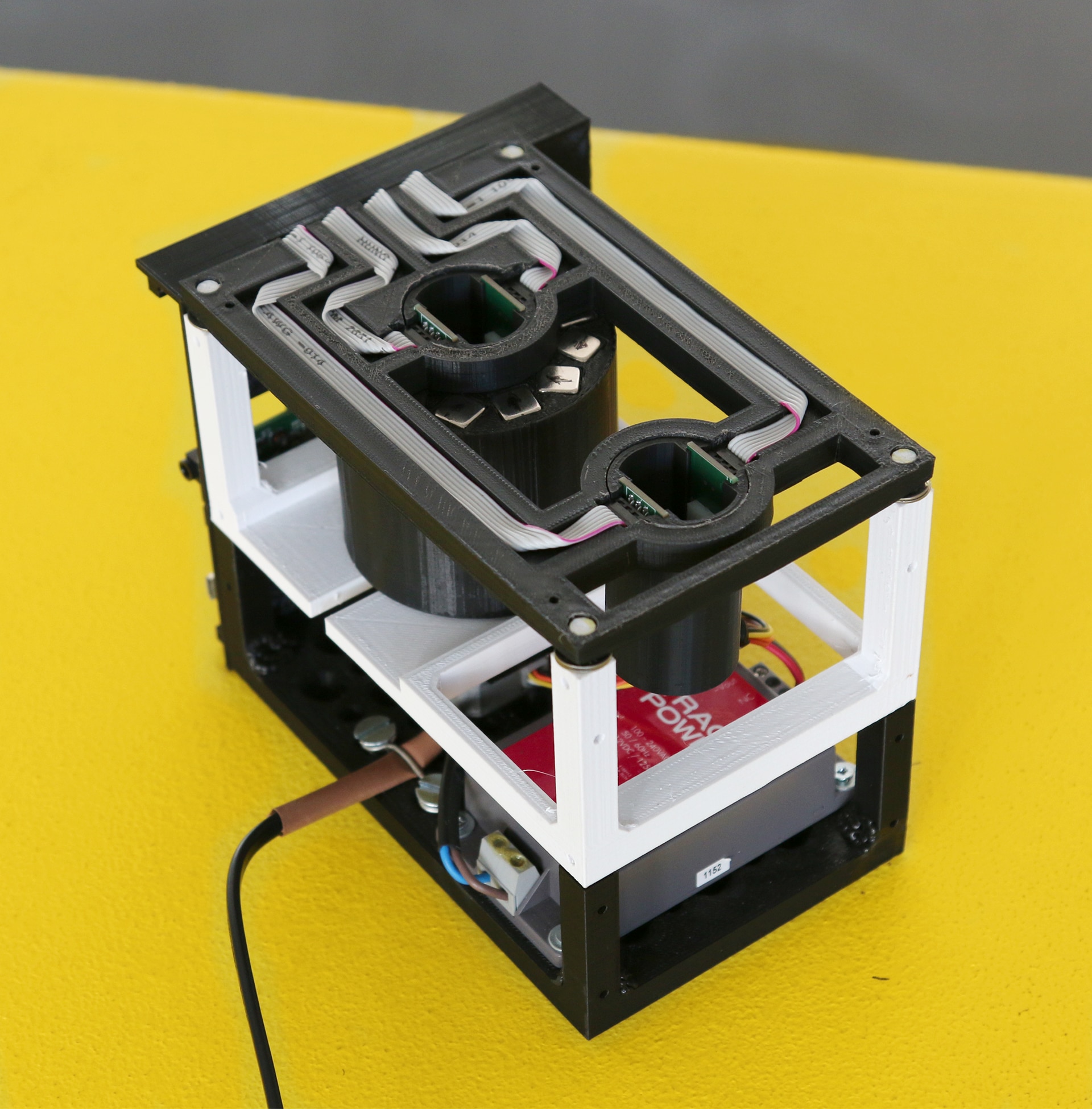   Close-up of a machine against a yellow background 