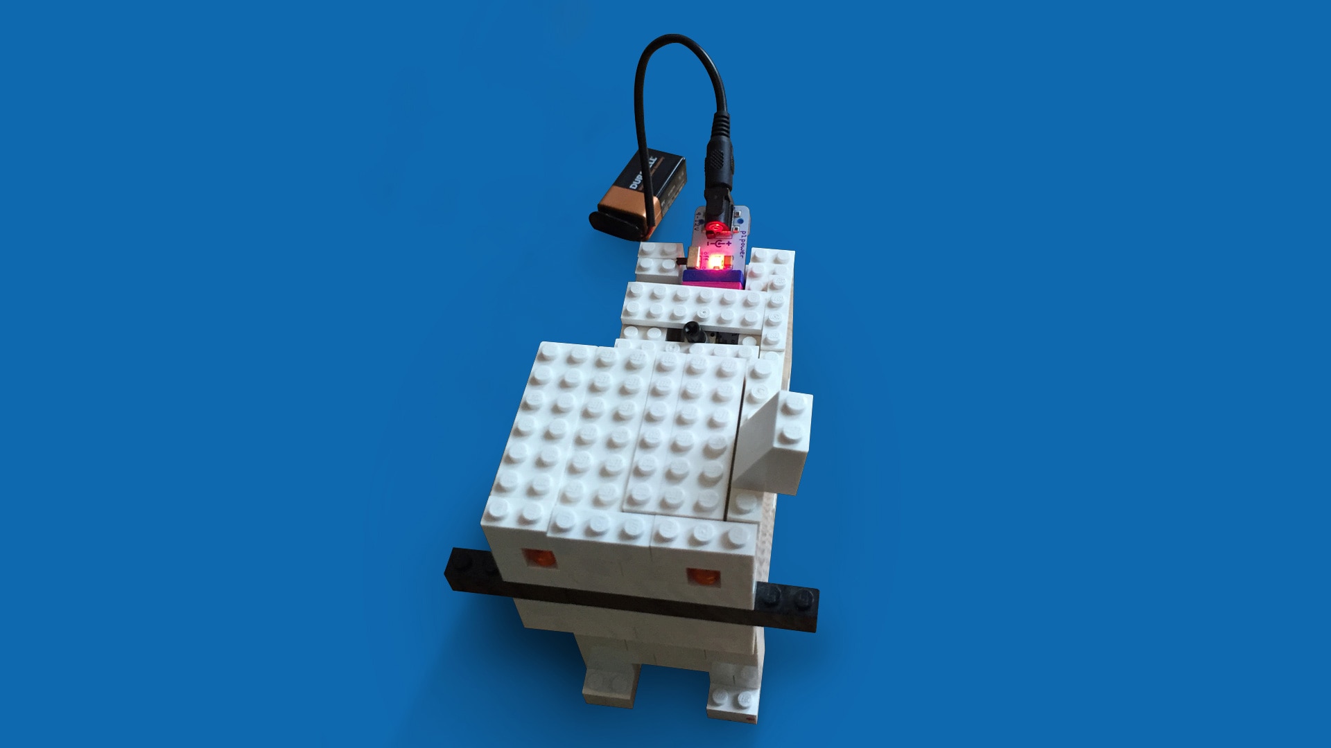   A lego animal attached to a battery