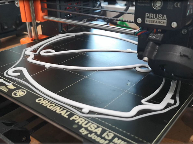 One of the four 3D printers producing the holders