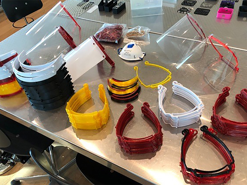 The 3D-printed holders for securing the shield to the wearer's head (front) and the foils (back) are assembled to the face protection.